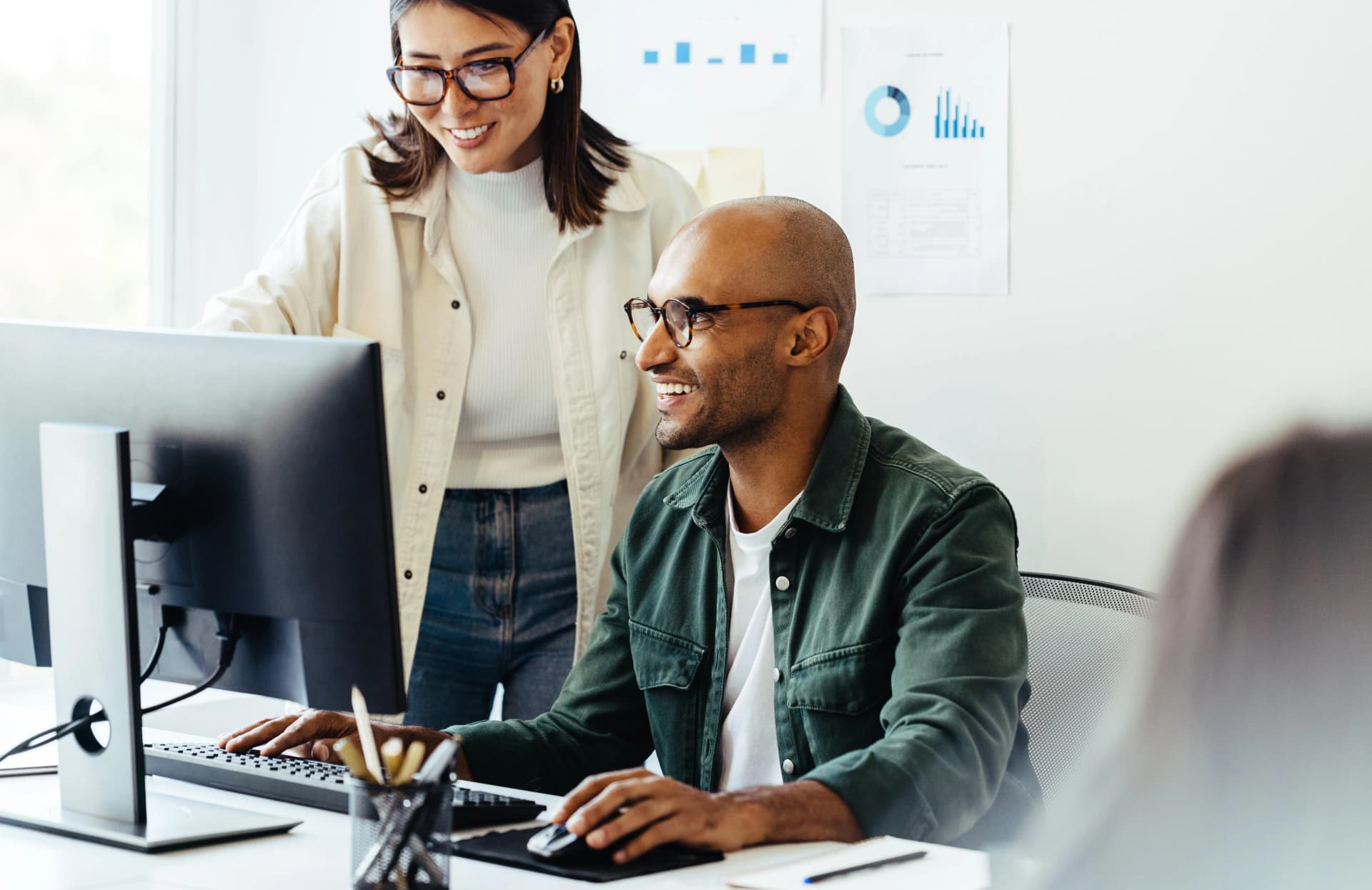 Professional Man And Business Woman Using Laptop